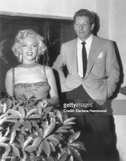 American actors Marilyn Monroe and Danny Kaye pose at the St. Jude Hospital Benefit, Hollywood, California. Monroe is wearing a gown she wore in the...