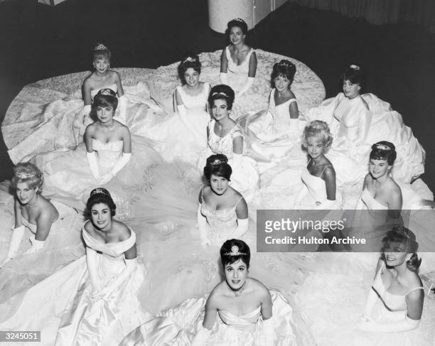 Winners of the 10th Annual Hollywood Deb Star Ball pose in gowns and tiaras, Hollywood, California.Karyn Kupcinet sits in the center .American actor...