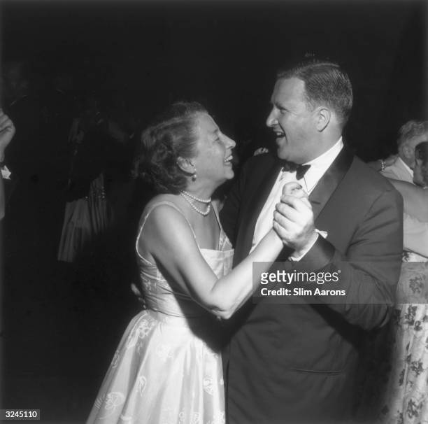 Automobile heir Henry Ford II dancing with his mother Mrs Edsel Ford at the Ford 50th anniversary party at the Ford Mansion in Palm Beach, Florida.