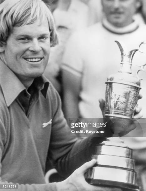 American golfer Johnny Miller holding his trophy after winning the British Open at Royal Birkdale in Lancashire.