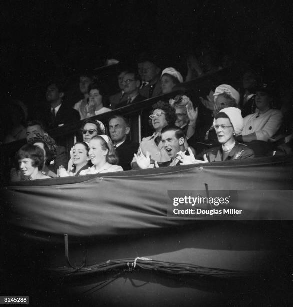 From left to right, Princess Anne, Prince Michael of Kent and his mother Princess Marina show their approval from the royal box at Wimbledon.