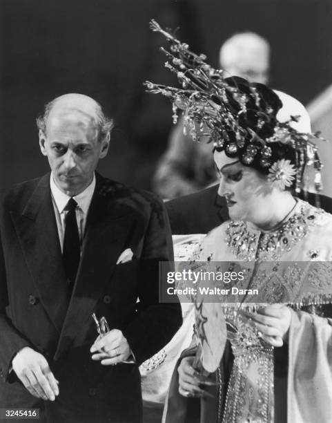 Metropolitan Opera manager Rudolf Bing stands next to Swedish soprano Birgit Nilsson, who is dressed in an elaborate Chinese costume, during a...