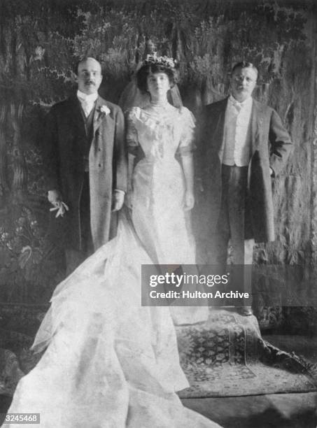 Wedding portrait of Nicholas Longworth and Alice Roosevelt posing with the bride's father, U.S. President Theodore Roosevelt. The bride is wearing a...