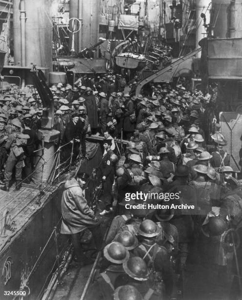 High-angle view of a crowd of uniformed Allied soldiers standing on a ship during the evacuation of British and French troops from Dunkirk.