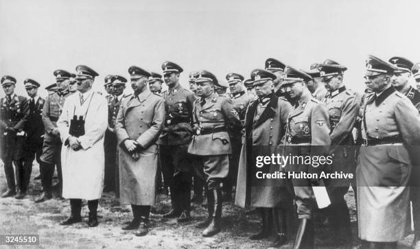 Nazi leader Adolf Hitler stands with Heinrich Himmler and his staff, contemplating the chances of an invasion while looking across the English...