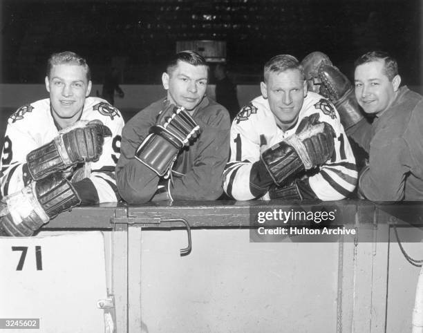 Left to right: hockey players Bobby Hull, Stan Mikita, Bill Ray and Glenn Hall, of the Chicago Black Hawks, waiting to get on the ice.