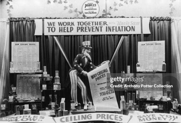 Store display with an Uncle Sam doll, anti-inflation signs, and store goods during World War II. A banner above the doll reads, 'We work together...
