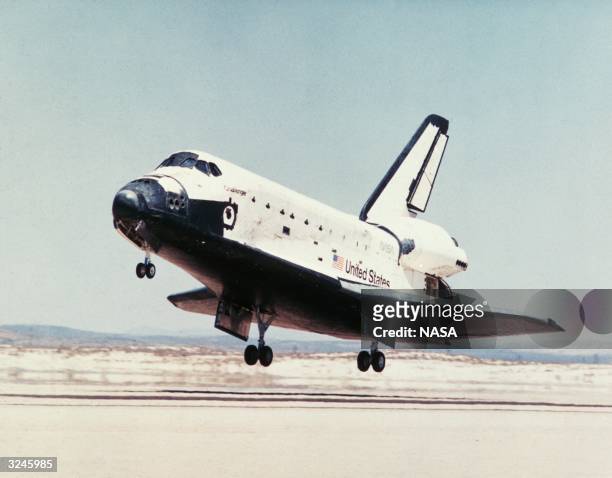 The United States Space Shuttle Challenger lands at Edwards Air Force base, California.