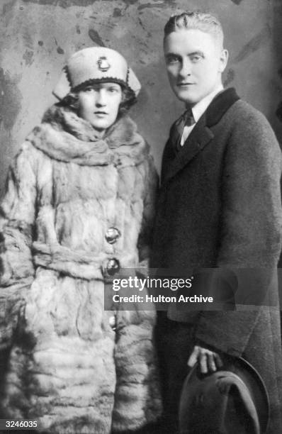 Portrait of American author F. Scott Fitzgerald and his wife Zelda wearing winter coats.