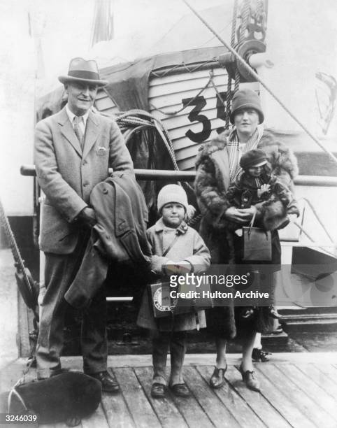 American author F. Scott Fitzgerald poses on a pier with his wife Zelda and their daughter Frances Scott , after arriving from Europe aboard a liner.