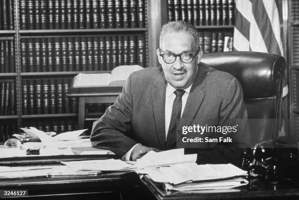 American jurist, lawyer, associate justice Thurgood Marshall , who had been recently appointed Solicitor General by President Lyndon Johnson, sits...