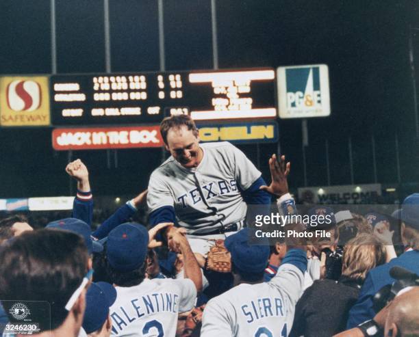 Texas Rangers pitcher Nolan Ryan smiles as his teammates carry him on their shoulders, celebrating his sixth no-hitter in their win against the...