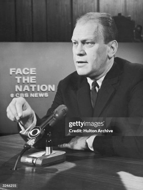 American politician Gerald Ford, Michigan representative and Republican Leader of the House, speaks into a microphone in a still from the CBS New...