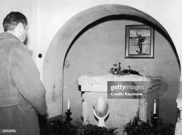 Vittorio Mussolini, son of Italian dictator Benito Mussolini, visiting his father's tomb at the cemetery in San Cassino, Province of Forli.