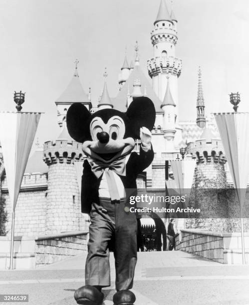 Person in a Mickey Mouse costume at the gate of the Magic Kingdom at the Disneyland theme park, Anaheim, California.