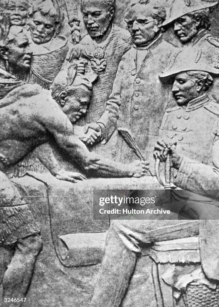 Low-relief sculpture of Governor William Hobson and the Maori chiefs signing the Treaty of Waitangi in New Zealand.