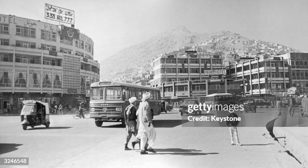 Pedestrians crossing a street near the Park Hotel in Kabul, Afganistan