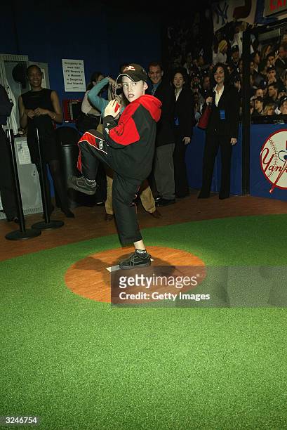 Member of the Gloria Wise Boys And Girls Club throws a pitch at the launch of a new interactive experience featuring a figure of baseball player...
