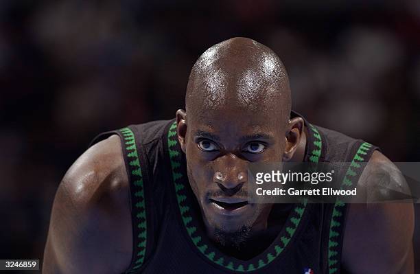Kevin Garnett of the Minnesota Timberwolves leans over during the game against the Denver Nuggets at the Pepsi Center on March 26, 2004 in Denver,...