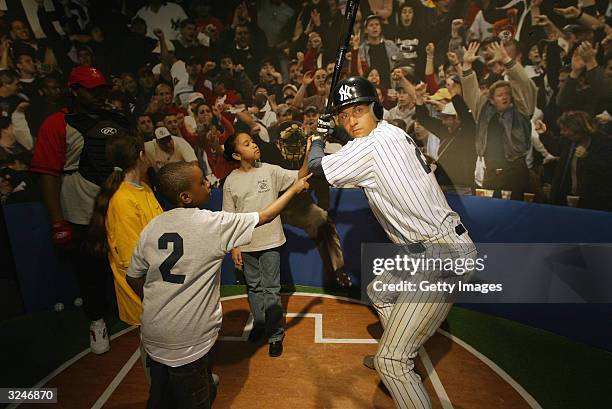 Members of the Gloria Wise Boys And Girls Club attend the launch of a new interactive experience featuring a figure of baseball player Derek Jeter at...