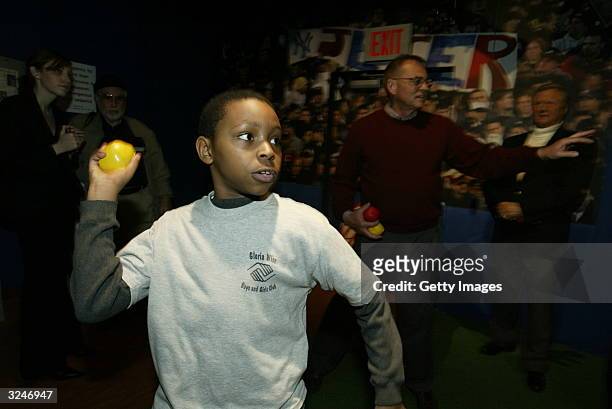Member of the Gloria Wise Boys And Girls Club throws a pitch at the launch of a new interactive experience featuring a figure of baseball player...