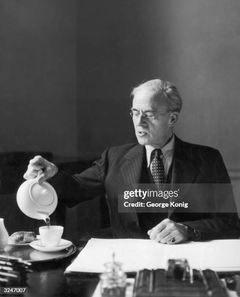 Chancellor of the Exchequer Sir Richard Stafford Cripps pours himself a cup of tea.