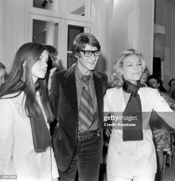 French designer Yves Saint-Laurent poses with American actress Lauren Bacall and her daughter Leslie, at a showing of his latest collection in Paris.