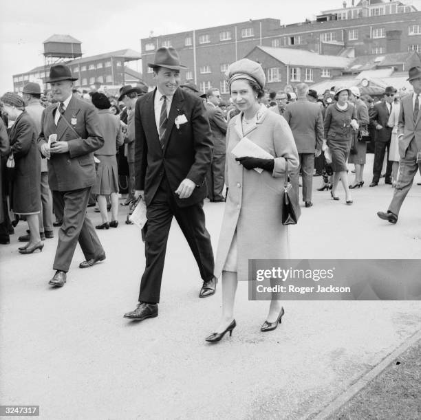 Queen Elizabeth II and Lord Porchester at Newbury Races. Lord Porchester took over from Michael Oswald as the Queen's racing manager in 1970.