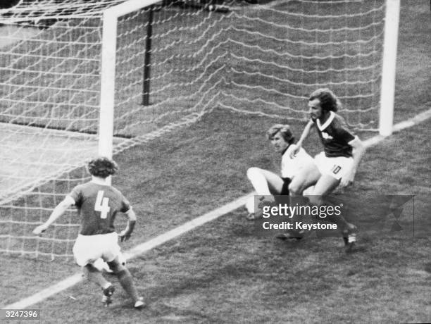 East German player Konrad Weise prevents a goal, watched by teammates Hans Juergen Kreische and goalkeeper Juergen Croy, during a World Cup match...