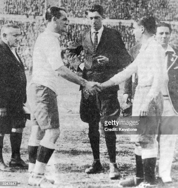 Uruguayan captain Jose Nazassi shakes hands with his Argentinian counterpart 'Nolo' Fereyra before the final of the first world Cup competition in...