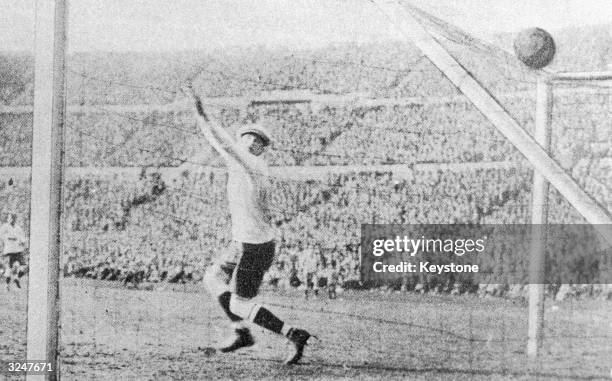 Uruguayan keeper Enrique Ballestrero fails to save a shot from Argentina's Carlos Peucelle to equalising the score at 2-2 in the final of the first...