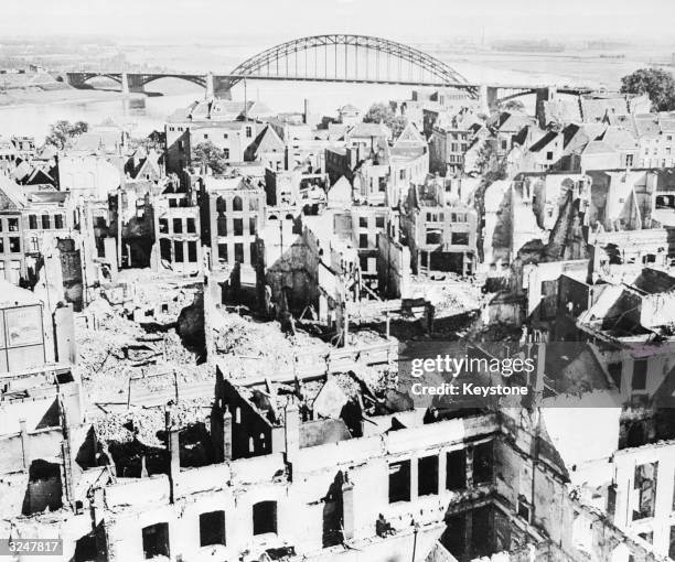 The ruins of Nijmegen, the oldest city in Holland, after heavy bombardment by both German and Allied forces in late September 1943. In the background...