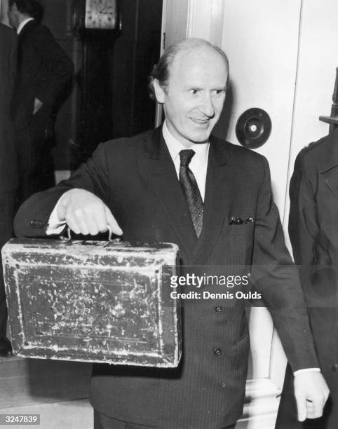 Chancellor of the Exchequer Anthony Barber holds up his budget case as he leaves Downing Street for the House of Commons, where he will present his...