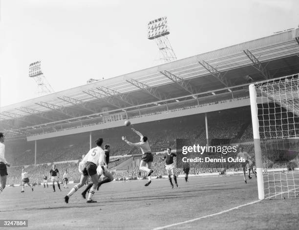 England goalkeeper Gordon Banks and centre-half Maurice Norman beat off an attack by Scotland centre-forward Ian St John during the soccer...