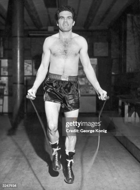 English boxing champion Freddie Mills , winner of the 1948 World Light Heavyweight title keeps in shape at his London gymnasium. He is preparing to...