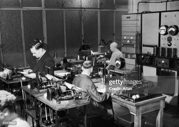 Men at work in the wire room at the Daily Express building in Fleet Street, London, where pictures are transmitted and received from around the world.