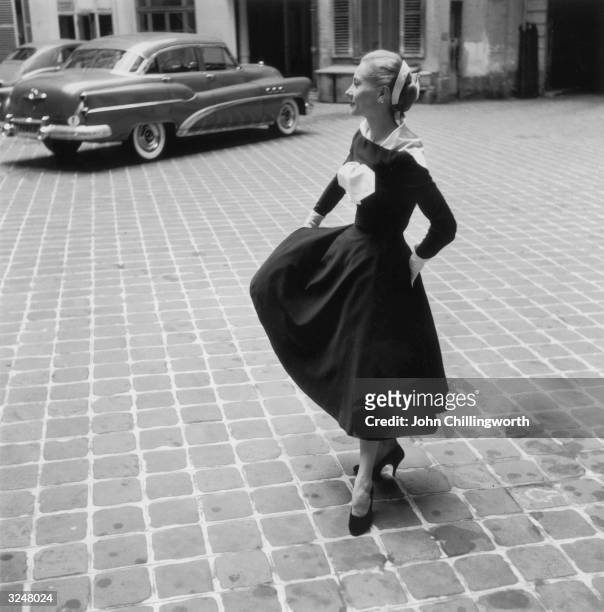 Model twirling a black and white dress with detachable scarf by Lanvin. Original Publication: Picture Post - 7264 - Fashion's New Alphabet - pub.1954
