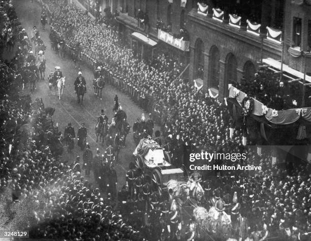 Crowds line the streets to watch the funeral cortege of Queen Victoria .