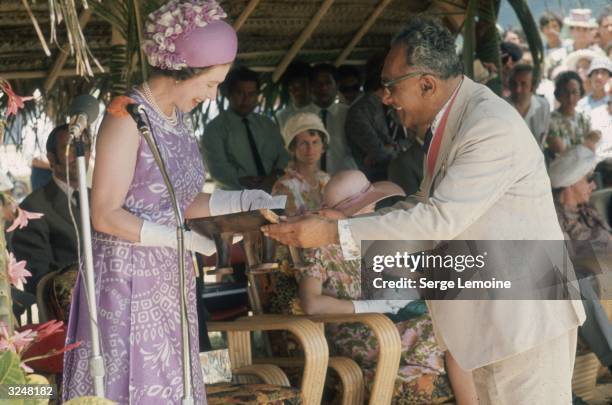 Queen Elizabeth II pays an official visit to the Cook Islands.