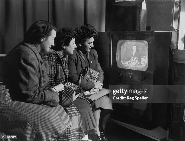 Mrs Adams gives a TV demonstration of knitting and rug making at a store on London's Oxford Street, watched by Mrs Freeman, Miss Hardy and Miss...