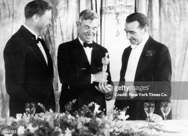 Left to right: American sound engineer Franklin Hansen, American actor and writer Will Rogers and Scottish-born director Frank Lloyd stand at the...