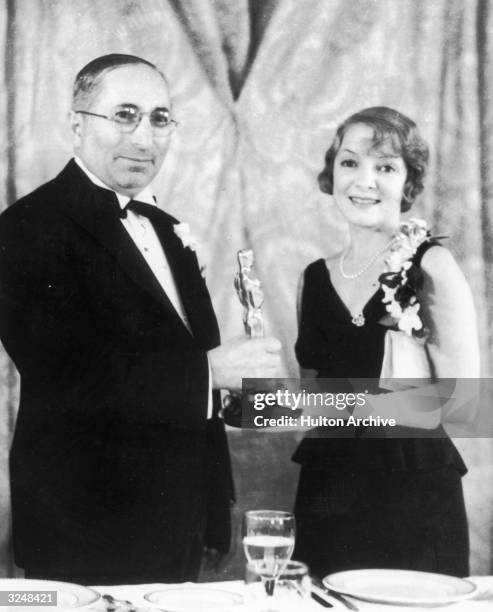Russian-born producer and Hollywood mogul Louis B. Mayer presents the Best Actress Oscar to American actor Helen Hayes for her role in director Edgar...
