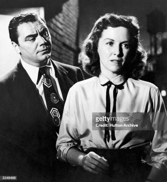 American actor Betsy Blair stands with her back to American actor Ernest Borgnine in a still from the film, 'Marty,' directed by Delbert Mann.