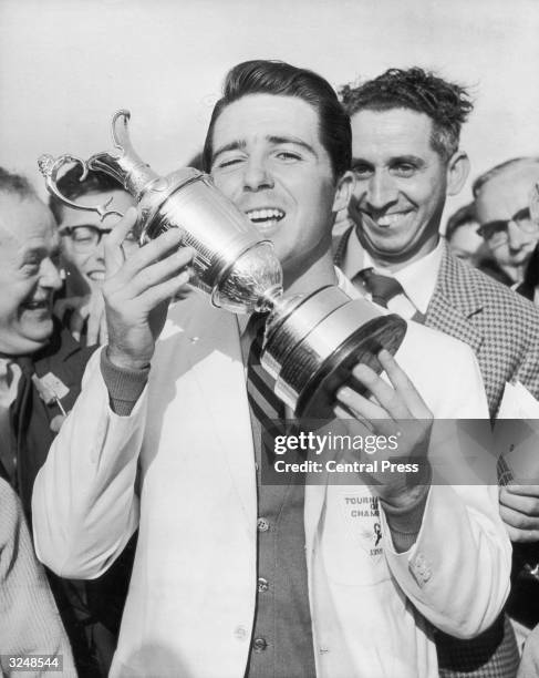 South African golfer Gary Player holds his trophy aloft after winning the British Open at Muirfield in Scotland.