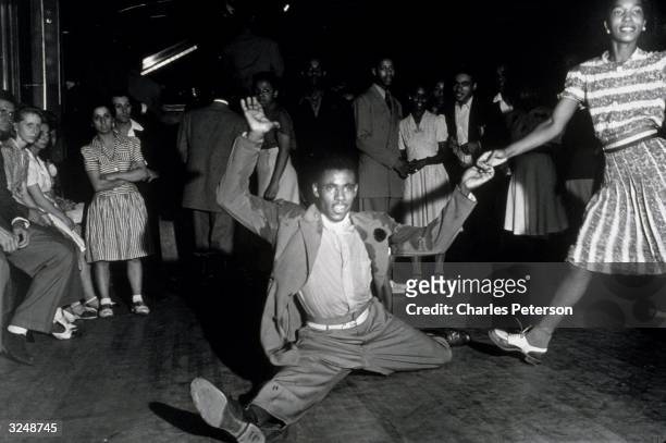 Lindy Hoppers swing dancing in the Savoy Ballroom in Harlem, New York City.