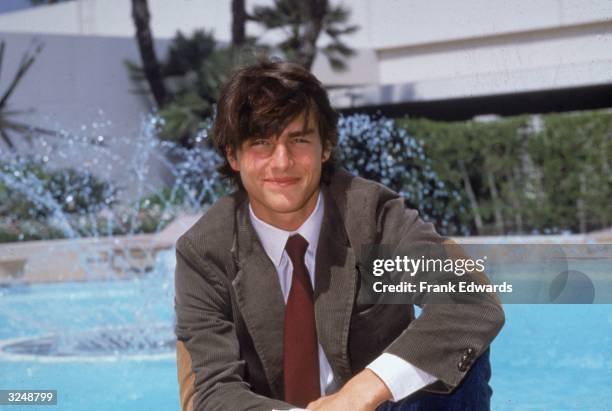 American actor Tom Cruise poses by a pool at the Beverly Hilton Hotel, Beverly Hills, California.