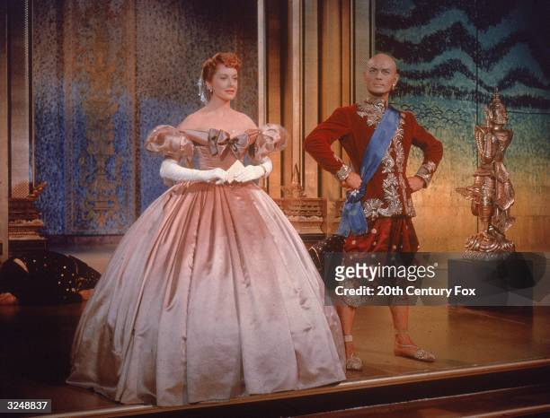 Russian-born actor Yul Brynner , as King Mongkut of Siam and Scottish-born actress Deborah Kerr, as Anna Leonowens stand side-by-side, wearing formal...