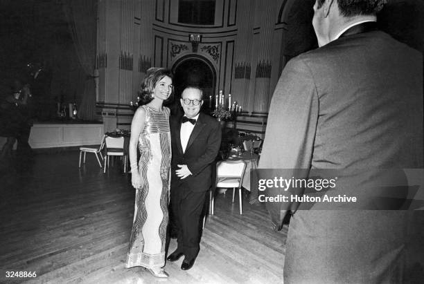 American socialite Lee Radziwill and American writer Truman Capote pose together in the Grand Ballroom of the Plaza Hotel during Capote's...