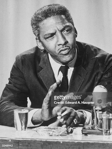 American civil rights activist Bayard Rustin , executive director of the Philip Randolph Institute, appears on a television program to discuss racial...