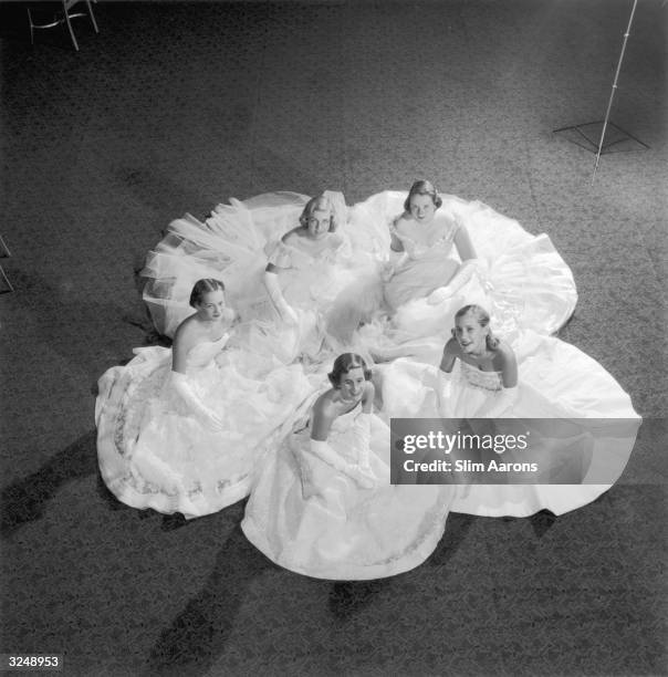 Five members of the Debutante Cotillion rehearse for the Christmas Ball at the Waldorf Astoria Hotel in New York. Clockwise from the bottom: Ann...